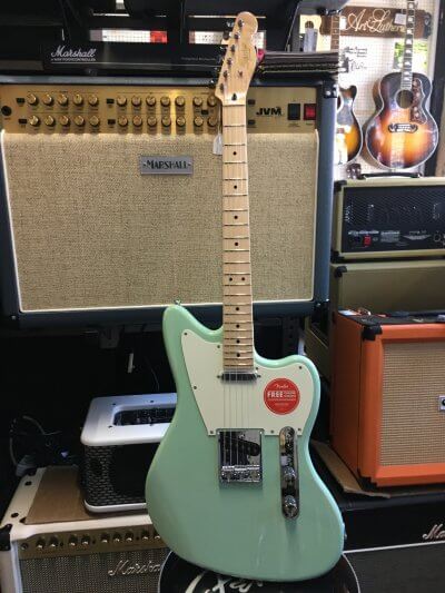 Featuring the brand new Squier Paranormal range from Fender. It offers unique guitars at very affordable prices. Top quality and amazing playability make these guitars stand out from the crowd. This is a offset Telecaster design in Surf Green. Spec: Body: Okoume Body Finish: Gloss Polyurethane Body Shape: Jazzmaster Neck Material: Maple Neck Finish: Gloss Polyurethane Neck Shape: "C" Shape Scale Length: 25.5" (648 mm) Fingerboard: Maple Fingerboard Radius: 9.5" (241 mm) Number of Frets: 22 Frets Size: Narrow Tall String Nut: Synthetic Bone Nut Width: 1.650" (42 mm) Position Inlays: Black Dot Truss Rods: Single Action, Head Adjust Bridge Pickup: Fender-Designed Alnico Single-Coil Neck Pickup: Fender-Designed Alnico Single-Coil Controls: Master Volume, Master Tone Pickup Switching: 3-Position Blade: Position 1. Bridge, Position 2. Bridge and Neck, Position 3. Neck Bridge: 3-Saddle Vintage-Style Strings-Through-Body Tele with Chrome Barrel Saddles Hardware Finish: Chrome Tuning Machines: Vintage-Style Pickguard: 3-Ply Parchment Control Knobs: Knurled Flat-Top